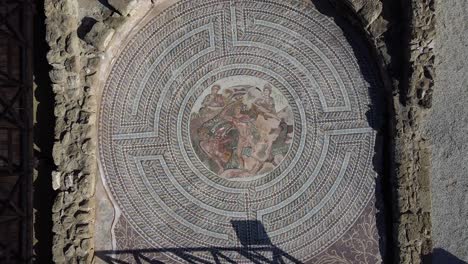 top-down view of an intricate greek mosaic on the floor of an ancient monastery