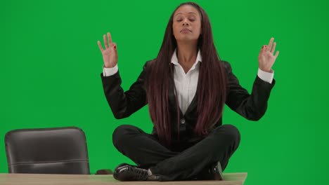businesswoman meditating on a desk