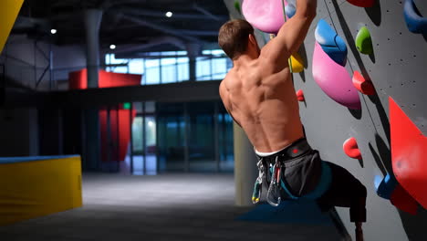 man with prosthetic leg rock climbing indoors