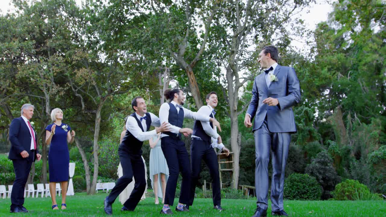 Garter toss by happy groom and groomsmen catch it 4K 4k