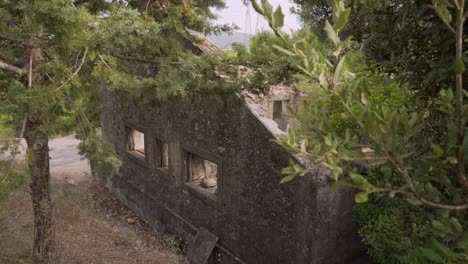 pedestal down shot of old abandoned house in the woods, located at parnitha mountain, athens, greece 4k