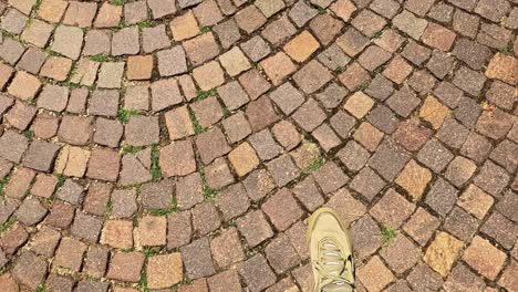 footsteps on cobblestone street in cuneo, italy