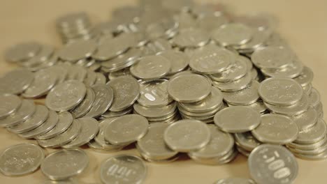 japanese coins, lying on table, close pan shot