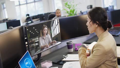 Composition-of-asian-businesswoman-using-computer-and-laptop-with-ai-call-on-screen