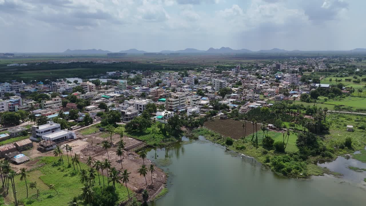 Captivating aerial footage of Vijayawada, where the natural terrain contrasts beautifully with the busy city scene.