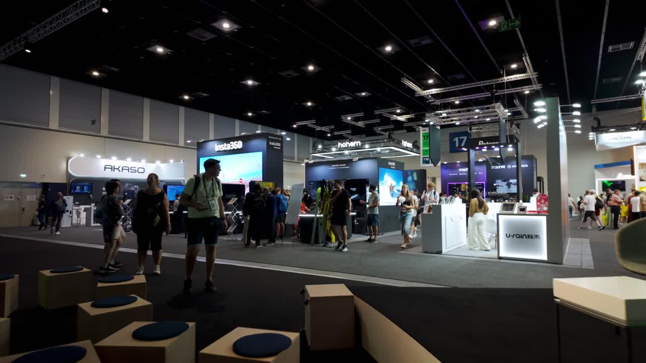 Wide view of the bustling exhibition hall at IFA Berlin, showcasing the latest in consumer and home electronics, with visitors exploring the various displays and booths.