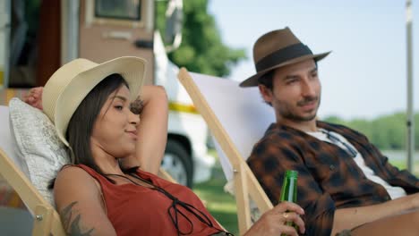 friends spending time on the camping side and drinking beer.