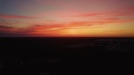 Lowering-aerial-view-of-the-sunset-in-Paradise-Beach,-Mexico