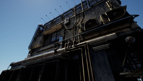 industrial building with exposed piping under clear blue sky