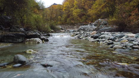 mountain river water flow with red and yellow trees autumn foliage aerial view