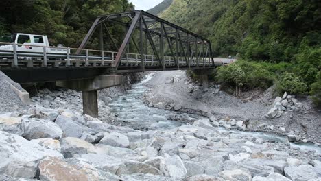 cars travelling over a bailey bridge in the southern alps of new zealand