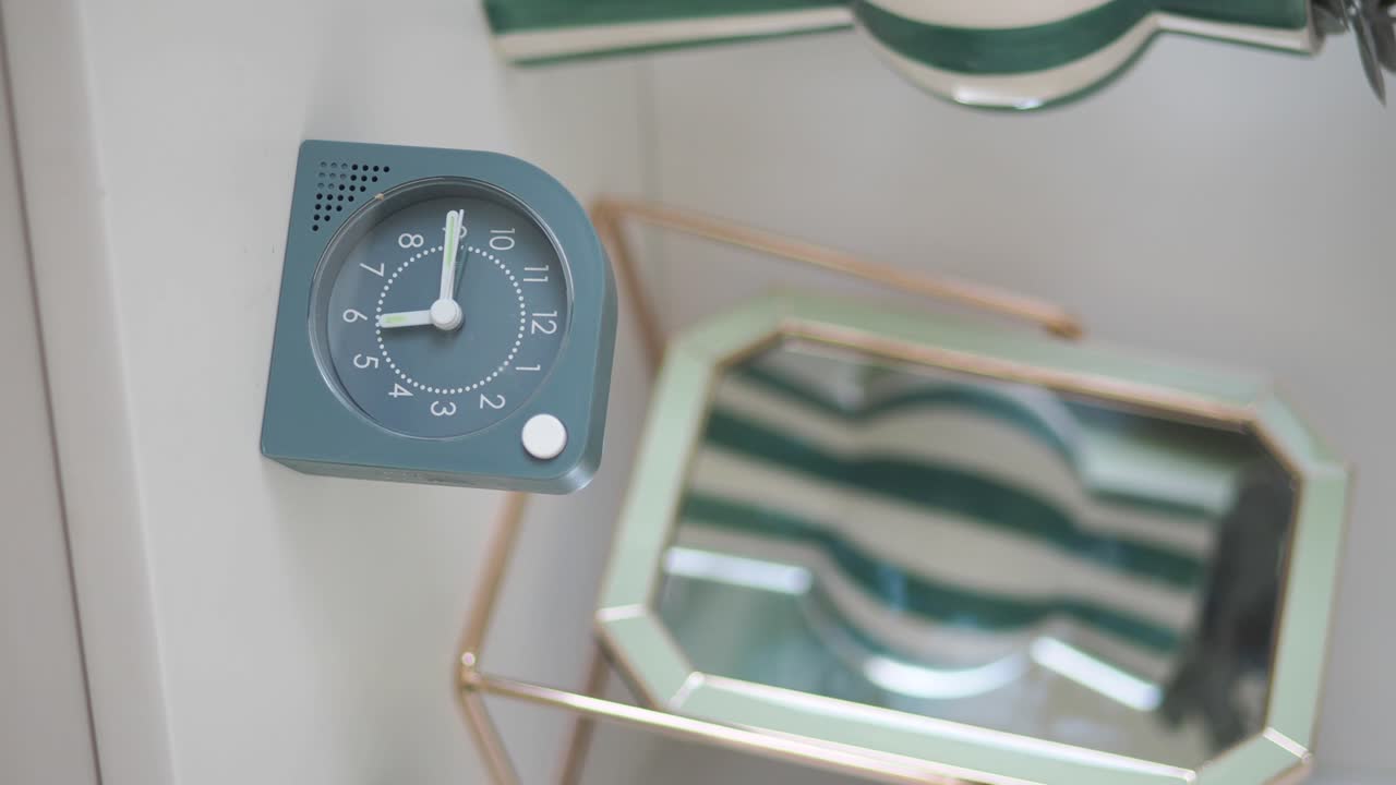 Small Teal Alarm Clock Showing Time Passing