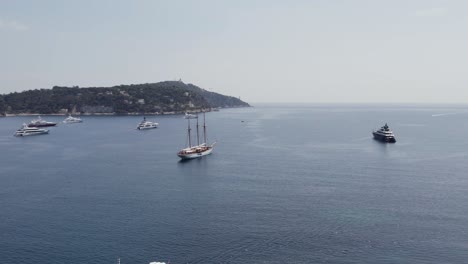 Triple-Masted-Yacht-Ship-on-French-Riviera,-Cote-d'Azur-Mediterranean-Coastline---Aerial-Drone-View
