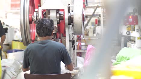 happy smiled worker doing his job on robotic factory line for processing and quality control of pure spring water bottled into canisters