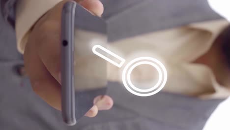 search magnifying glass animation appears on a mobile phone held by a person in a suit