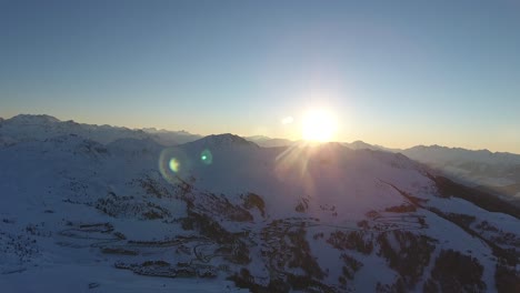 drone view sunset over la plagne a french ski area in the alpine valley.