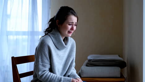 a sad woman is crying