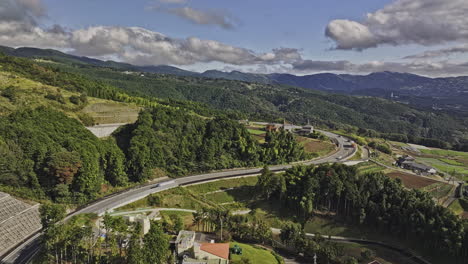 Mishima-Japan-Aerial-v2-drone-flyover-Sasahara-Shinden-showcases-a-scenic-drive,-capturing-farmlands-and-rolling-hillside-landscapes-under-a-beautiful-sky---Shot-with-Mavic-3-Pro-Cine---October-2023