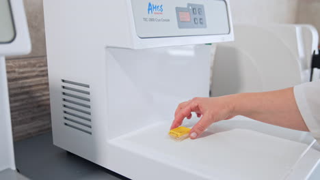sample specimen collection process. hand of geneticist technician holding tube with biological sample
