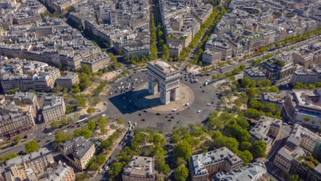 flight over paris city sunny day famous triumph arch traffic circle streets aerial timelapse panorama 4k france