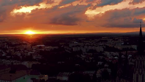 aerial view of idyllic summer sunset and dramatic sky above small european city