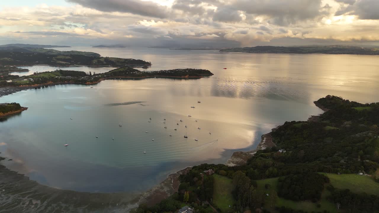 Parking boats in bay of blackpool beach on Waiheke island, New Zealand. Aerial wide shot. Peaceful and calm landscape in the morning.
