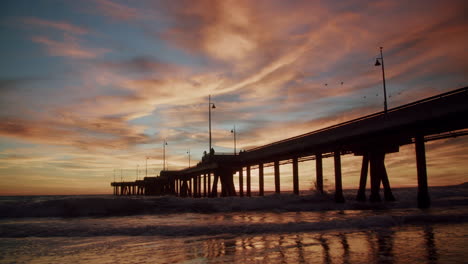 dramatic sunset over ocean pier