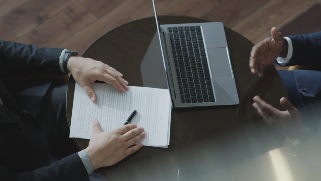 Top Down of Businessmen Talking and Shaking Hands