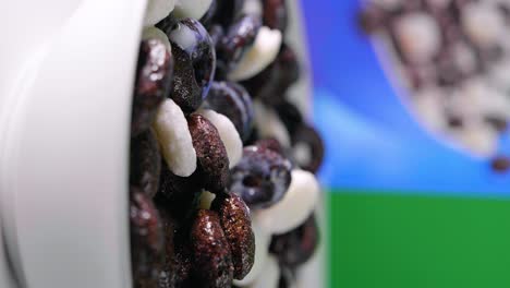 close-up of cereal bowl with vegan milk or oat milk pouring, vertical shot