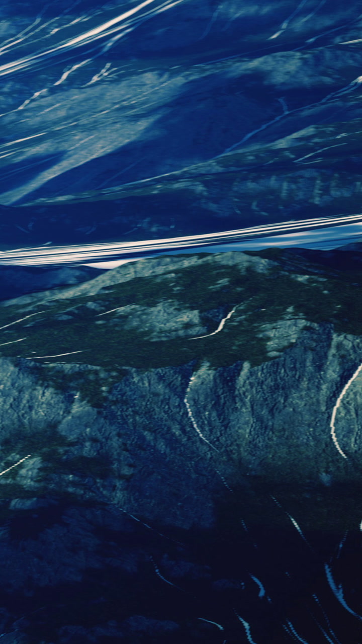 Mountains and rivers form patterns in the landscape during daytime