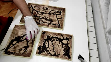 pouring epoxy resin in the holes in oak wood