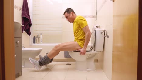 Man struggles with painful diarrhea in bathroom