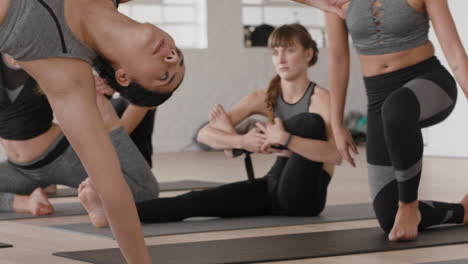 yoga class group of healthy women stretching preparing for morning workout practicing poses enjoying healthy lifestyle training in fitness studio