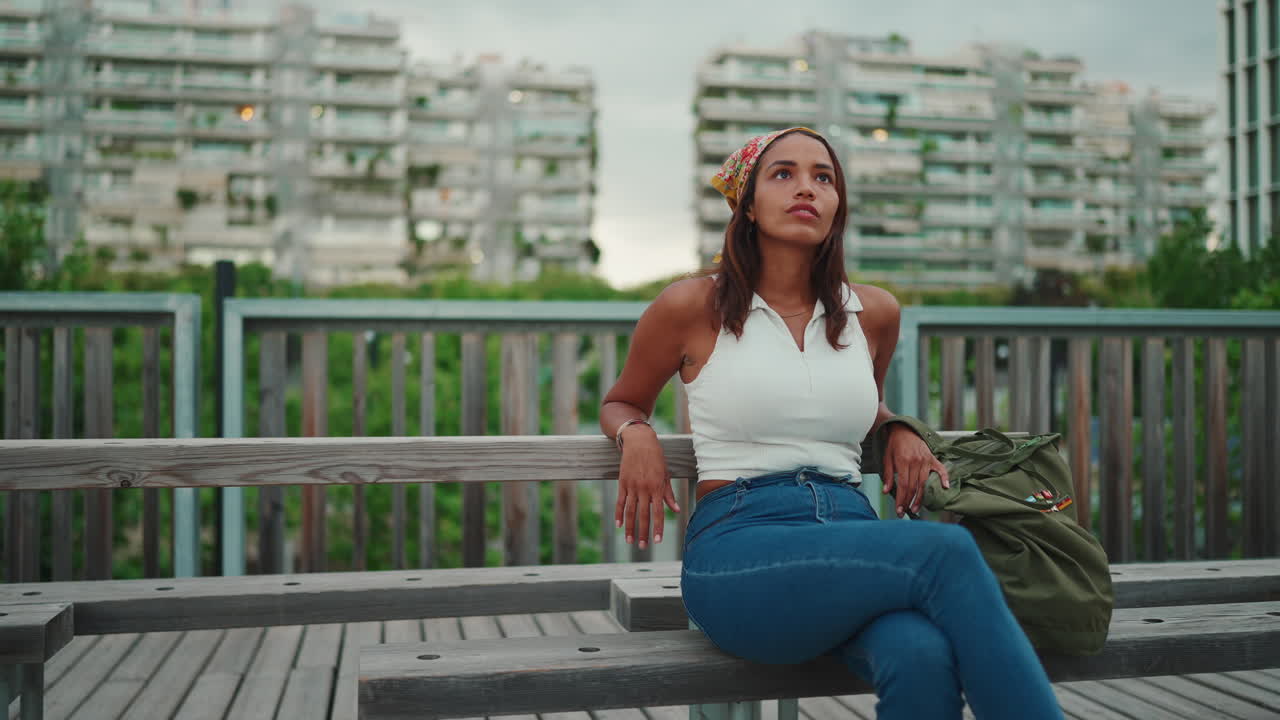A woman sitting on a bench in the city