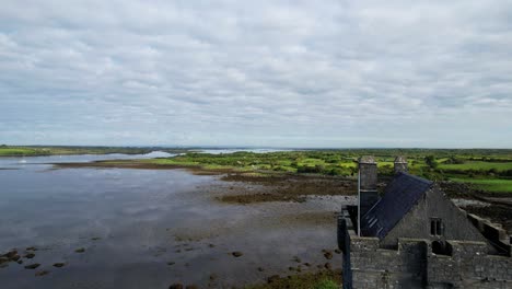 Forward-rising-shot-over-Dunguaire-Castle-in-Galway-County,-Ireland