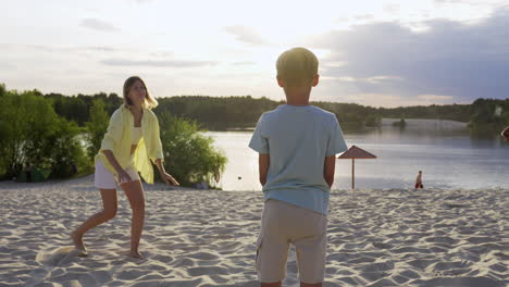 family playing on the beach