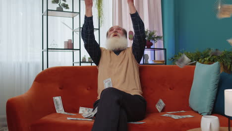 money cash dollars falling on senior man celebrating success winning good news, lottery jackpot luck