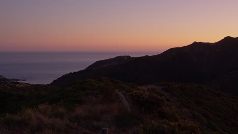 Beautiful-summer-sunset-silhouette-at-the-shore-in-Wellington,-New-Zealand