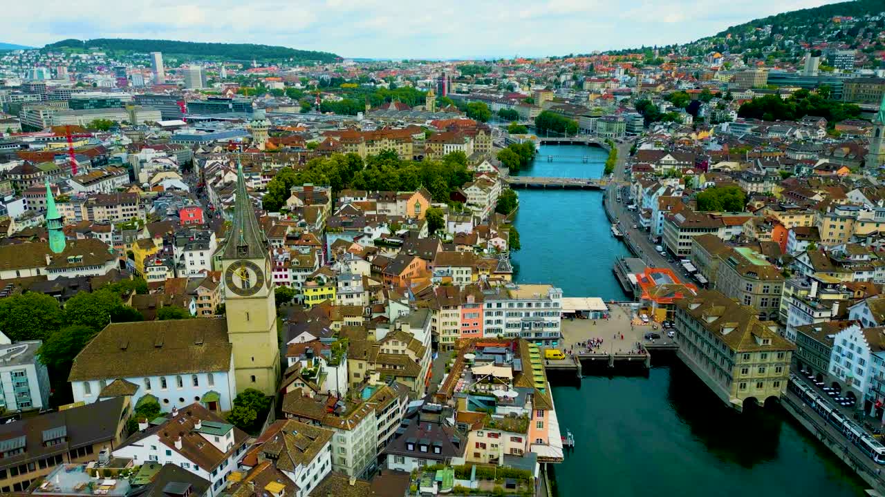 4K Drone Video of the Historic Grossmünster, Fraumünster, Predigerkirche, and St. Peter Churches on the banks of the Limmat River in Downtown Zurich, Switzerland