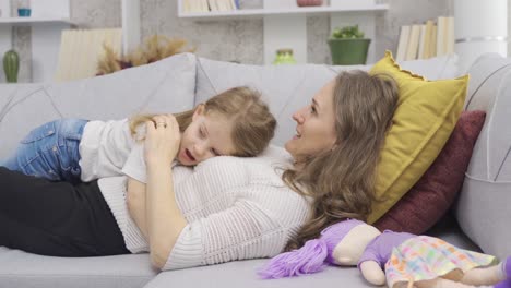 Mother-and-daughter-lying-down,-hugging-each-other.