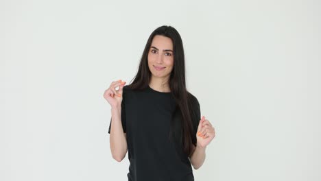 young woman making small gesture on white background