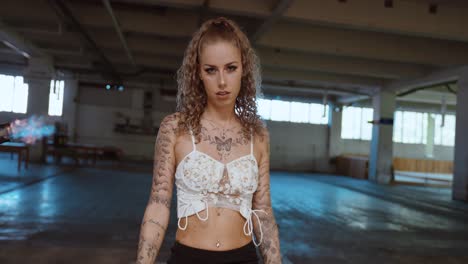 tattooed woman with fire explosion in dramatic cinematic scene