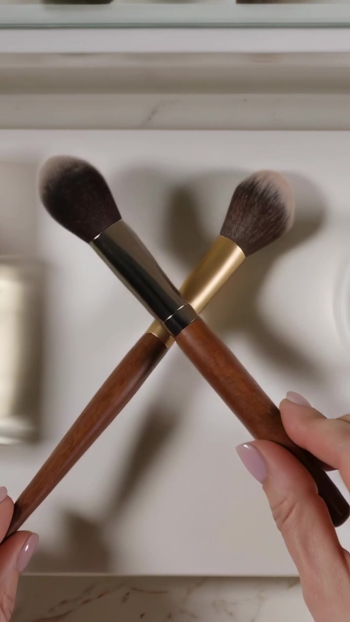 Vertical video: Blurred hands bringing cosmetics onto vanity, arranging bottle and brushes for shot