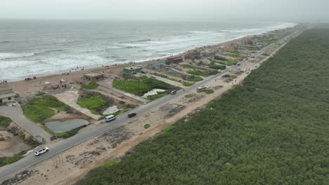 Aerial-View-Of-Beach-Huts-Beside-Hawkes-Bay-And-Mangrove-Forest-Plantation-In-Karachi