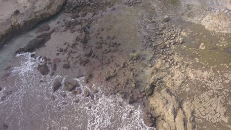 watu lumbung beach in gunungkidul, yogyakarta. a beach with unique large rocks and corals. the waves crash against each coral.