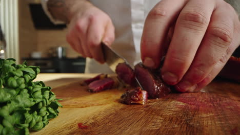 chef cutting meat in the kitchen