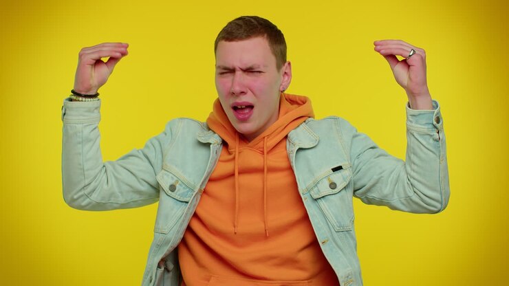 Tired irritated teen man showing nonsense gesture with hands, gossips, empty promises, blah, lier