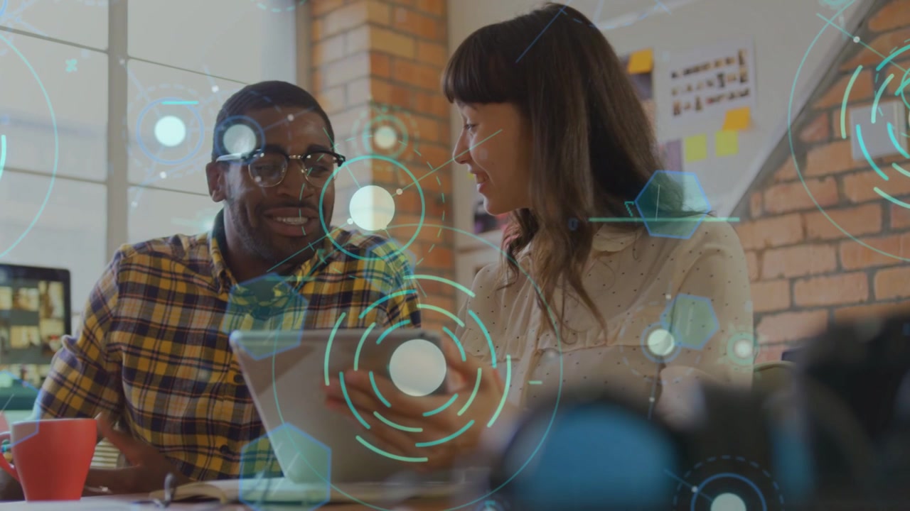 Woman tapping tablet, colleagues leaning in, reviewing tablet HUD, gesturing, reaching agreement