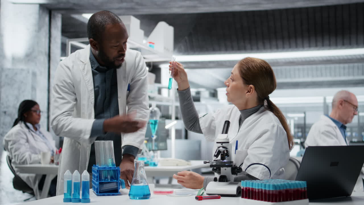 Clinical laboratory technologists in lab evaluate compound solutions