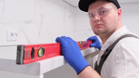 man installing a kitchen countertop
